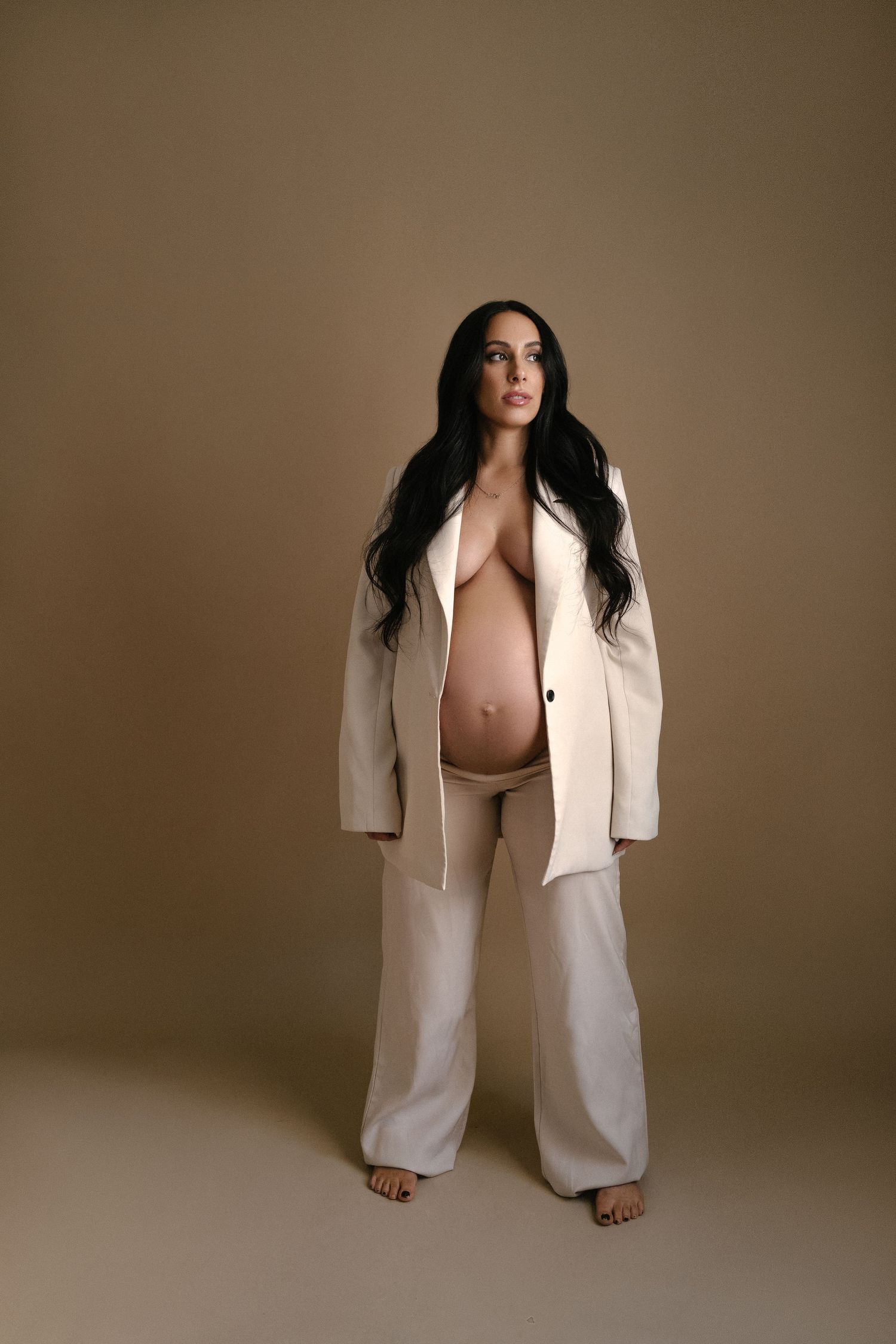 Full-length maternity portraits in cream tones with oversized white blazer.