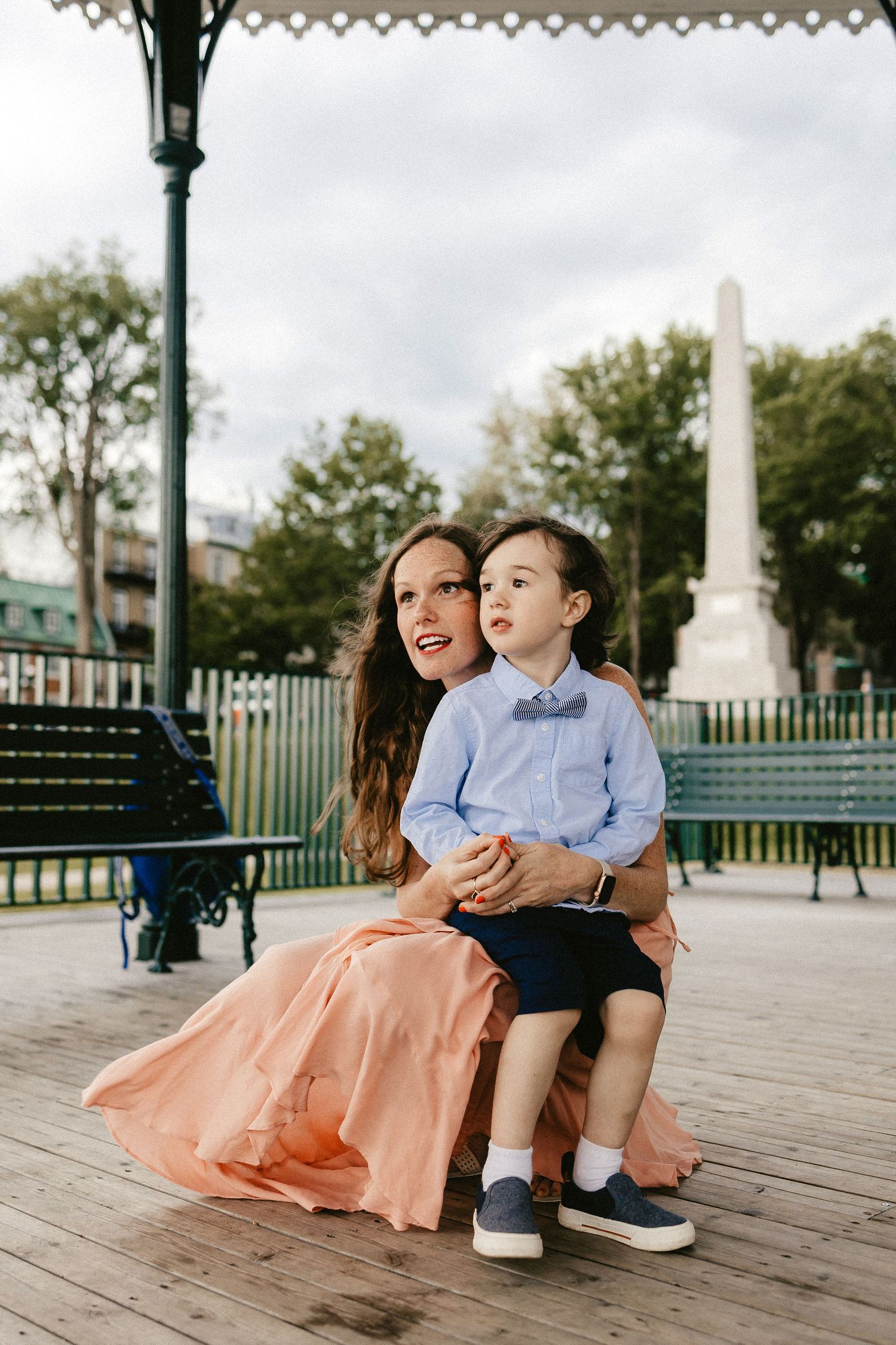 A tender moment shared on a gazebo bench overlooking a scenic view.