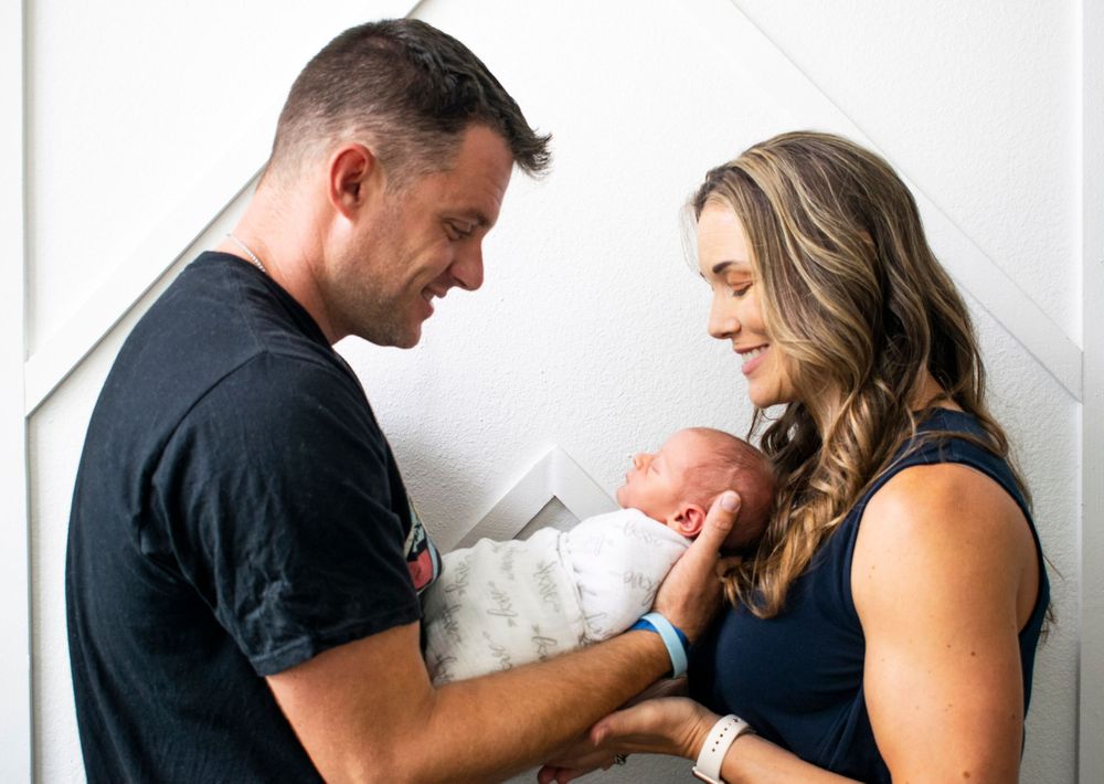 Couple holding newborn son.