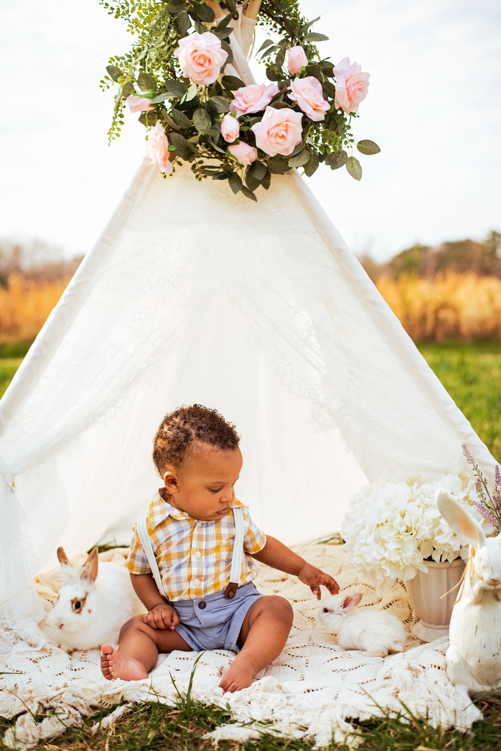 baby in a tepee with baby bunnies