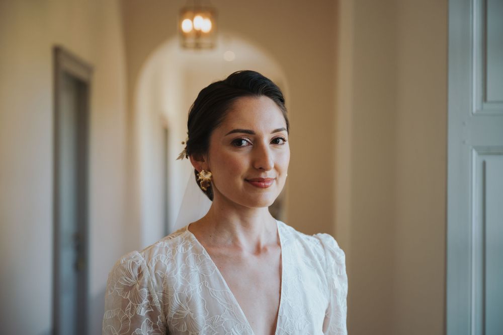 A close-up portrait of a bride wearing a delicate lace wedding gown.