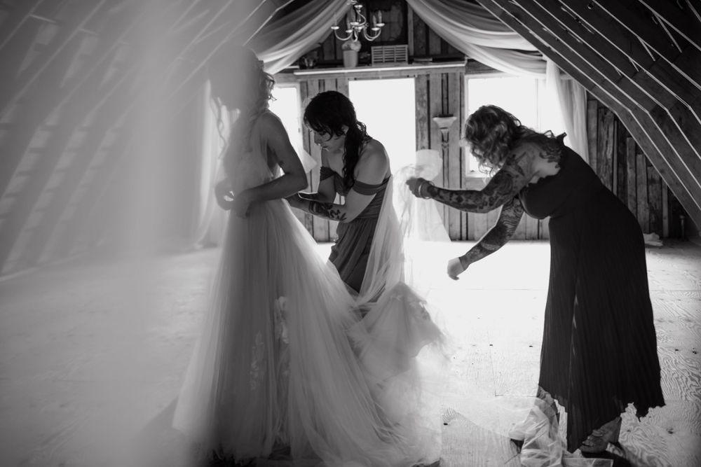 Preparations for a wedding ceremony in a rustic attic space with dramatic lighting.