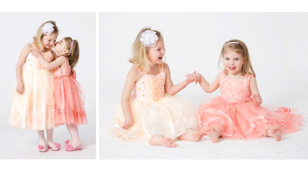 Two young girls in pastel tulle dresses pose together in matching studio portraits.