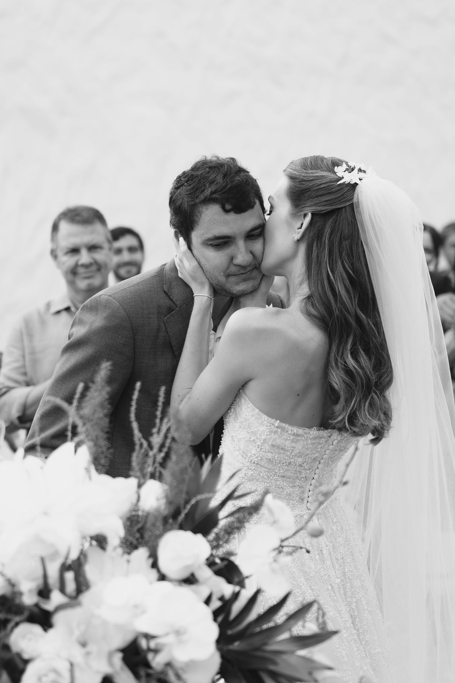 Black and white intimate moment between newlyweds during outdoor garden ceremony.
