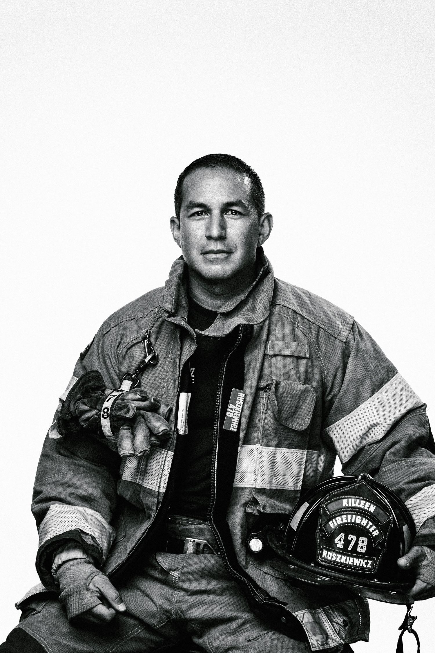 Black and white portrait of firefighter in protective gear.