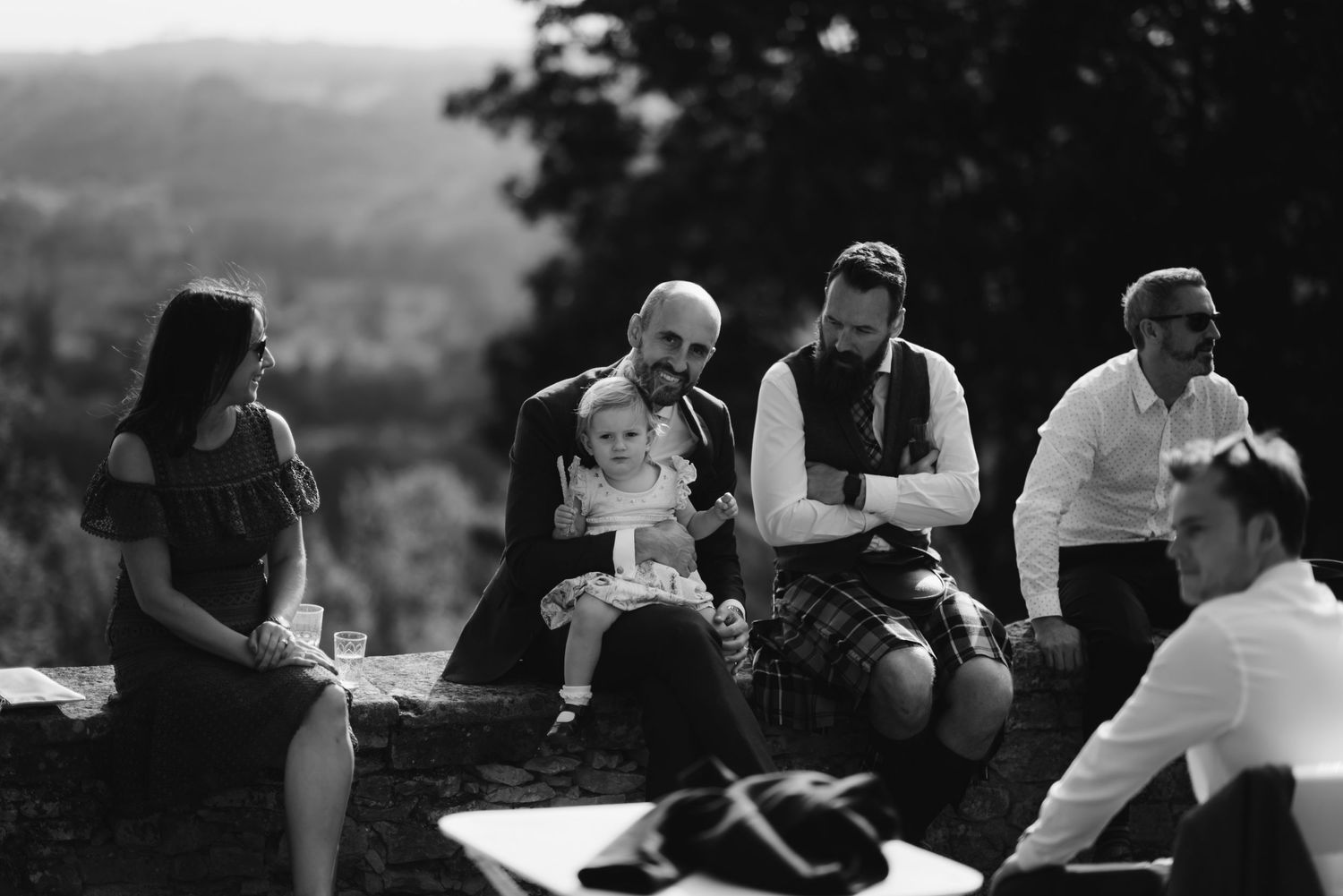 People gathered outdoors for casual conversation during an evening event.