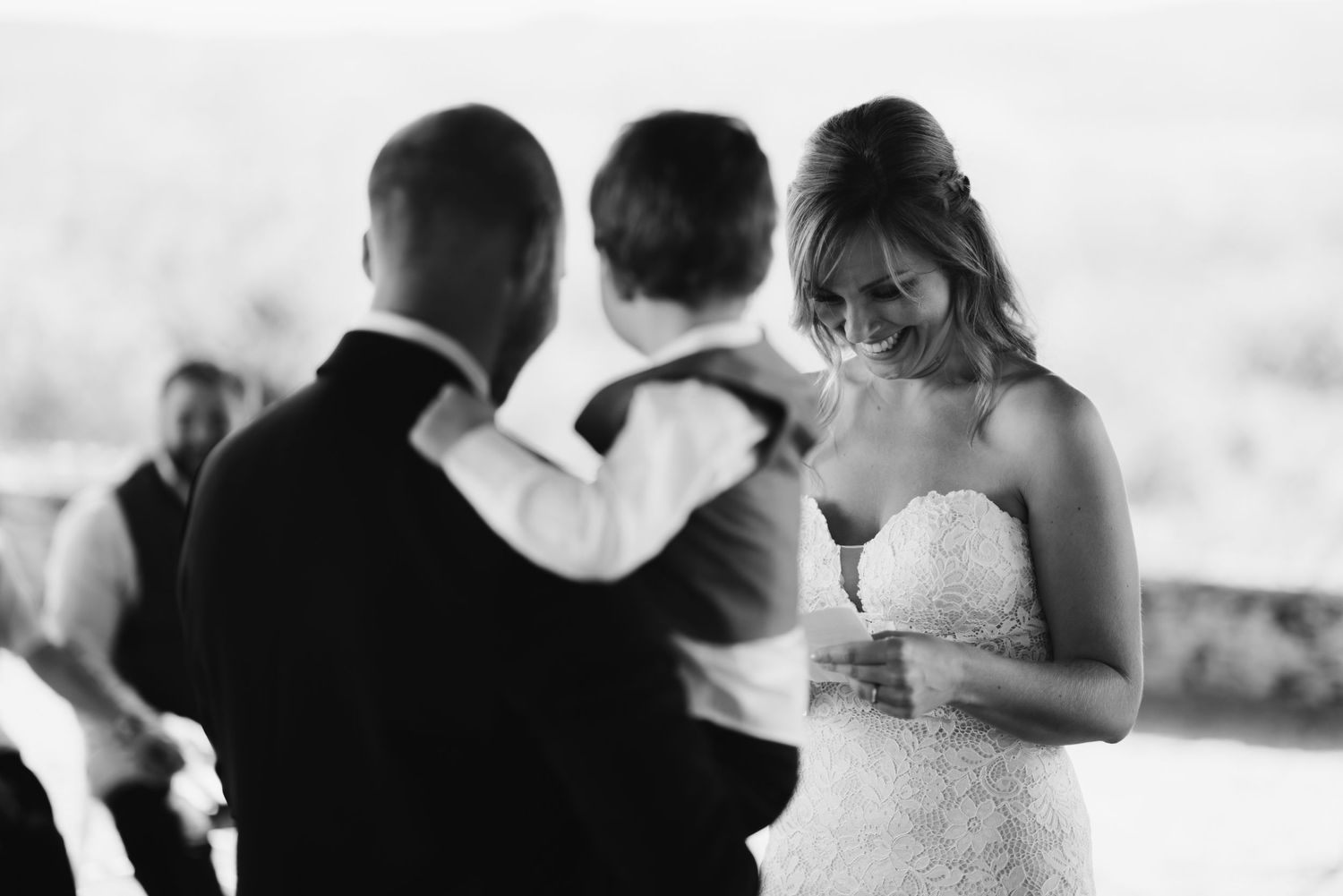 A black and white photo capturing an emotional moment during wedding vows.