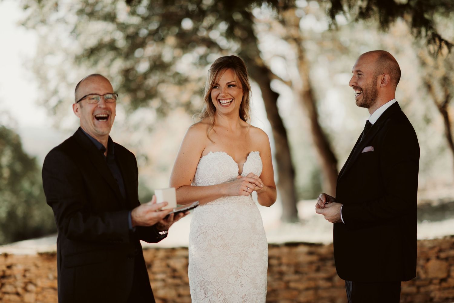A joyful moment during an outdoor wedding ceremony with laughter and smiles.