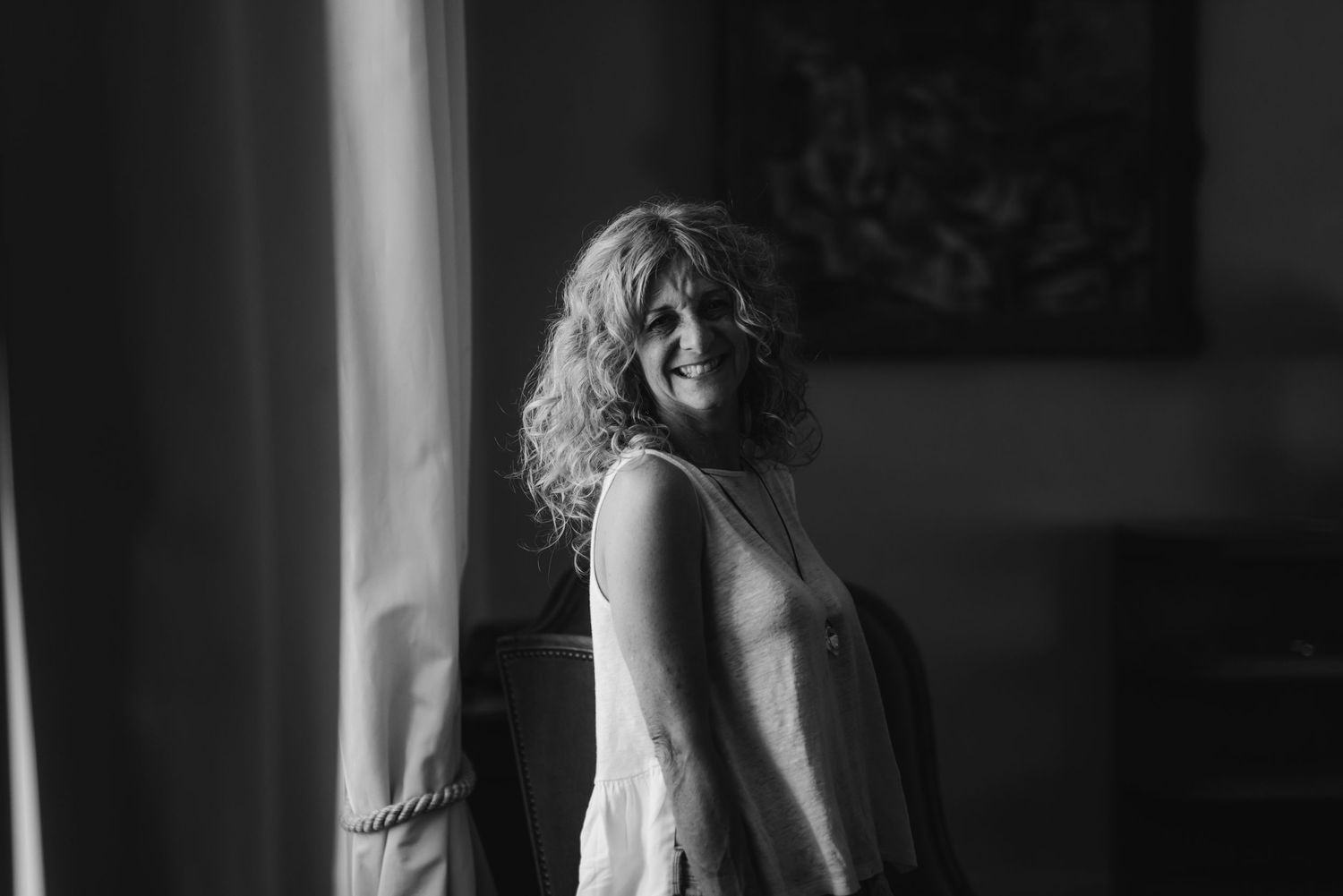 Artistic black and white side profile near window with natural light streaming in.