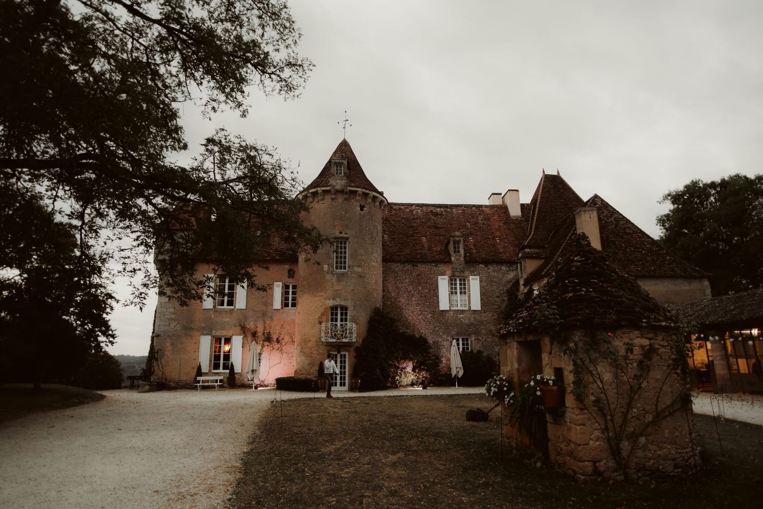 A grand French chateau with turrets and traditional architecture at dusk.
