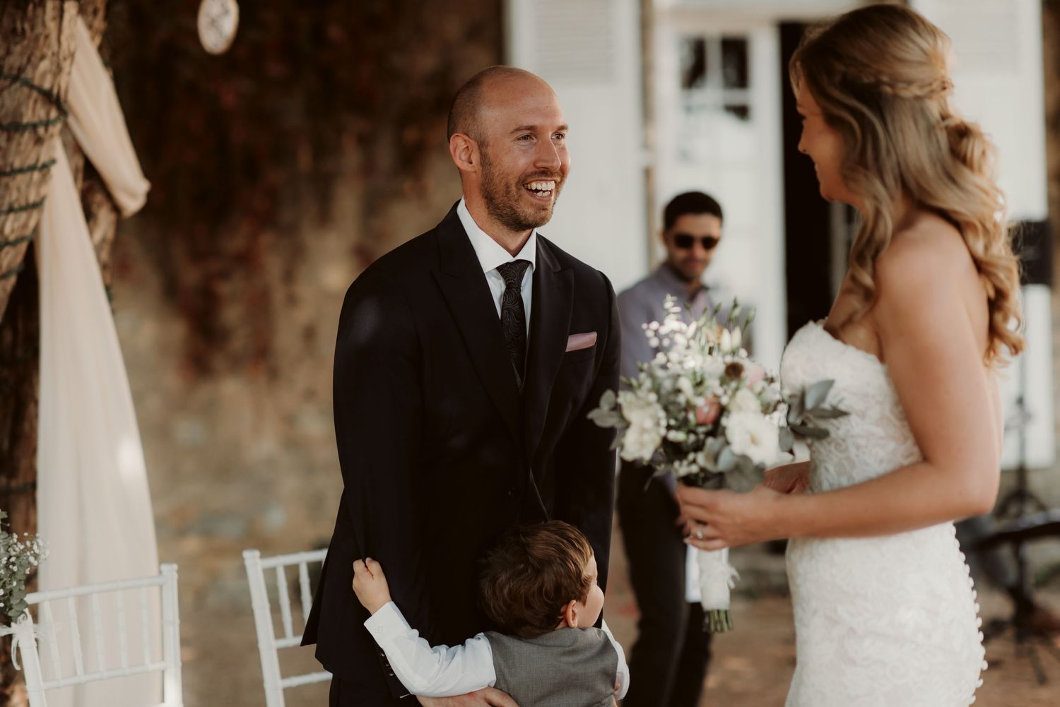 A couple shares a touching moment during their outdoor wedding ceremony.