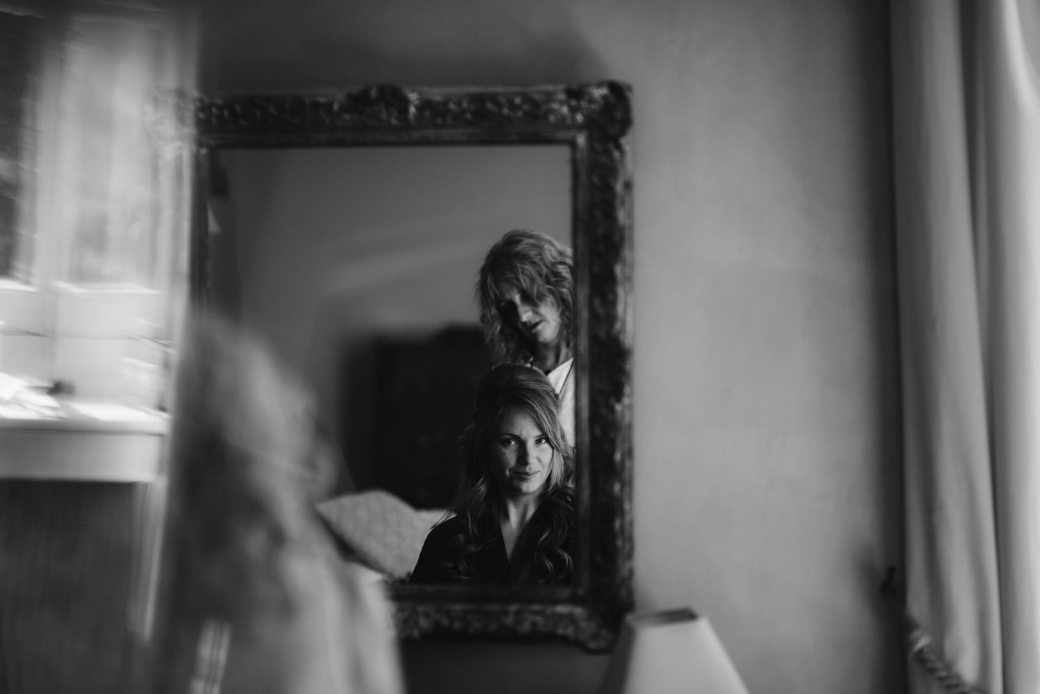 Artistic reflection captured in antique frame with moody black and white tones.