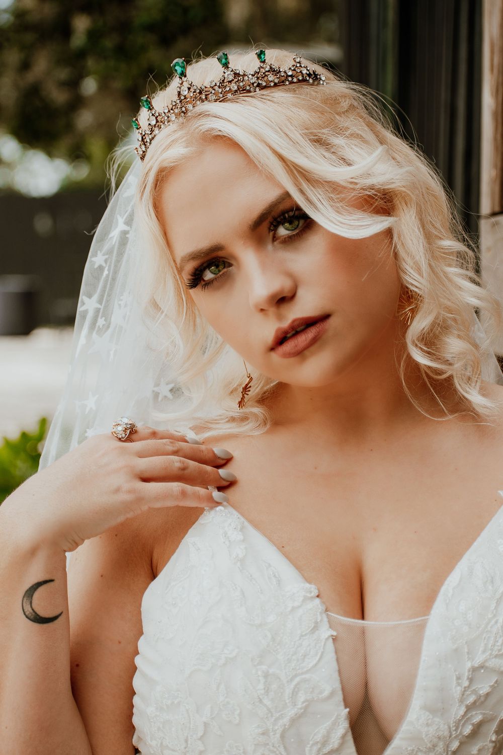 Romantic bridal portrait featuring a crystal crown and white lace gown.