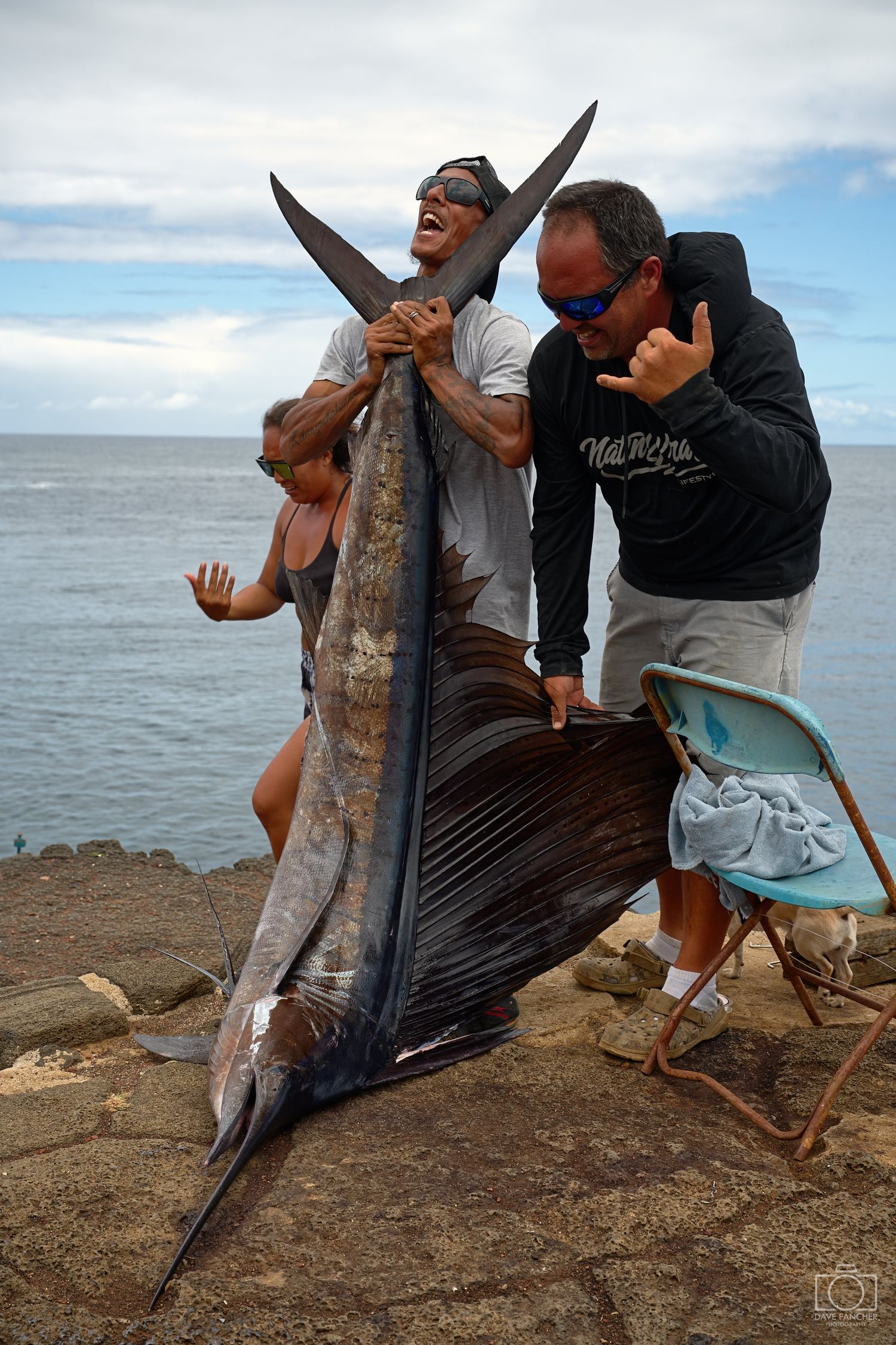 Fishermen celebrate catching a sailfish at Hawaii's South Point