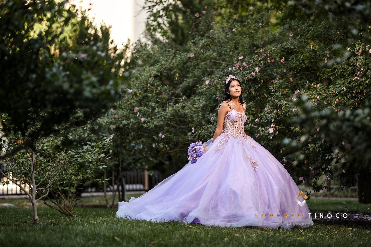Dreamy lavender princess gown captured during golden hour in a garden setting.