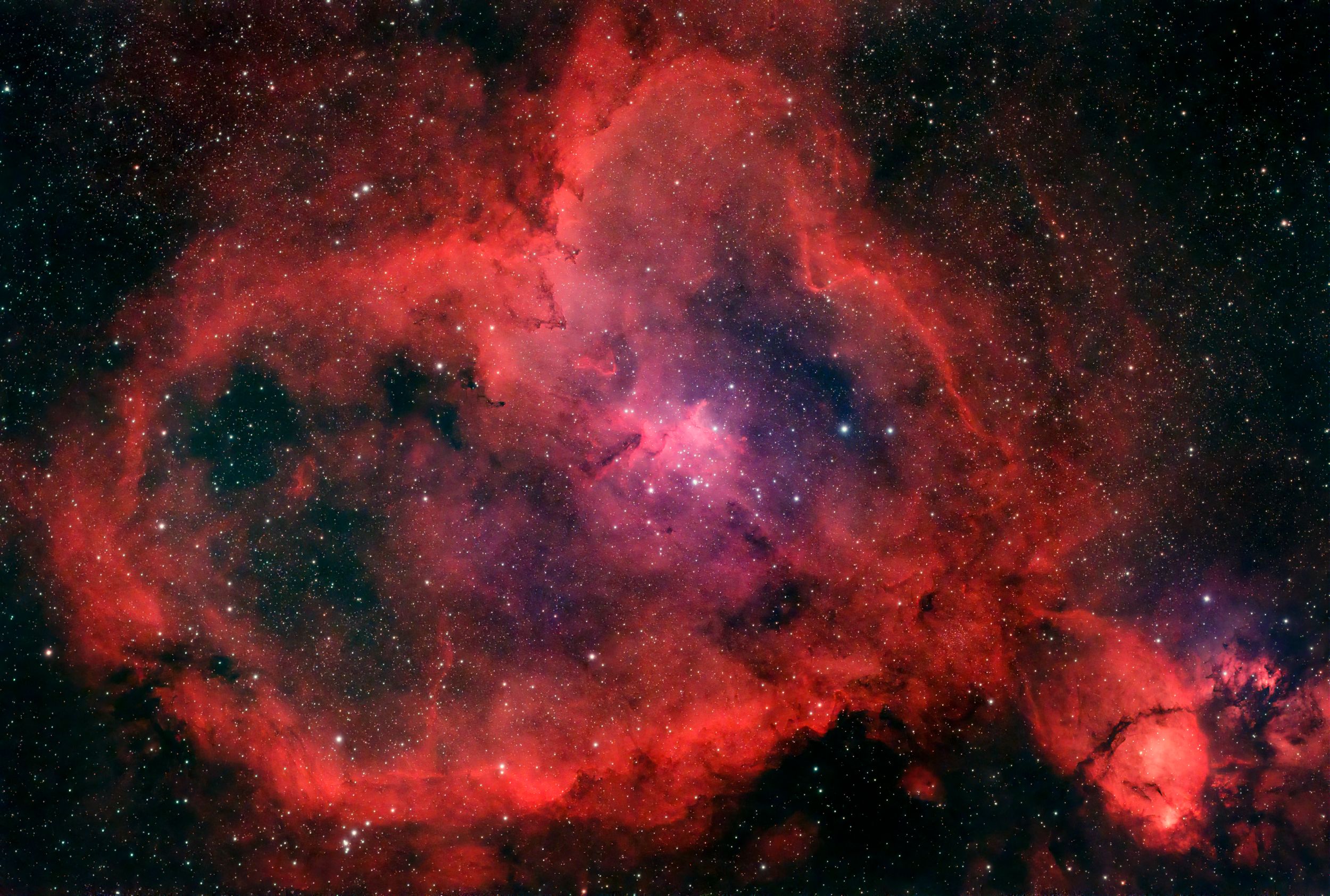 The Heart Nebula glows in vibrant red hues across the cosmic expanse.
