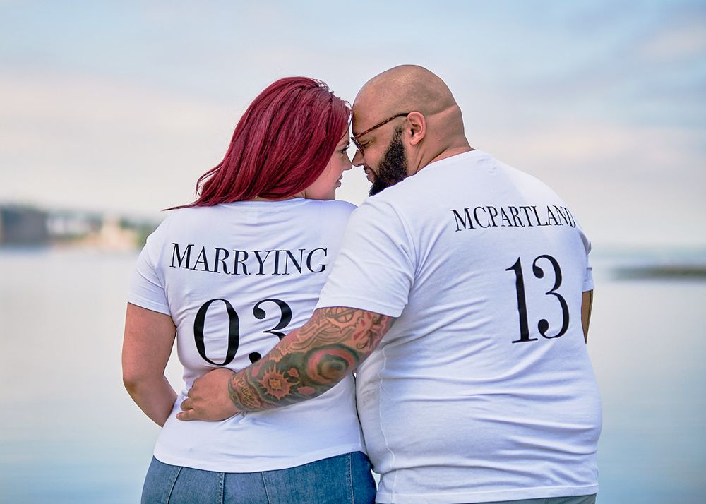 Custom matching wedding date shirts showing '03' and '13' against waterfront backdrop.