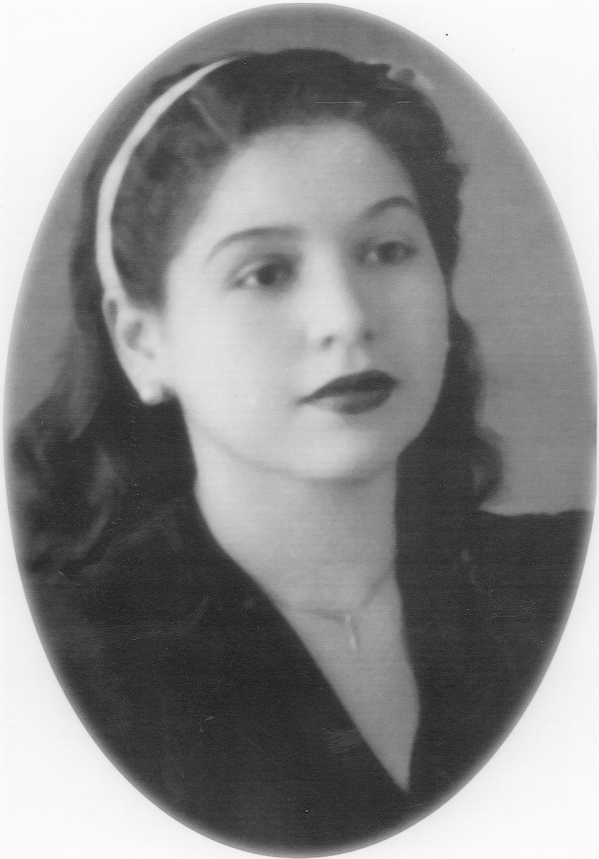 A black and white portrait photograph from the 1940s showing an elegant woman in dark lipstick and wavy hair.