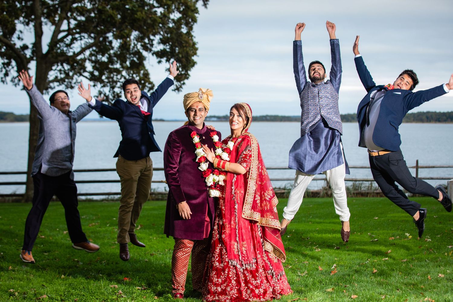 Bride and Groom with Wedding Party taking pictures and enjoying outside- Long Island Photographer