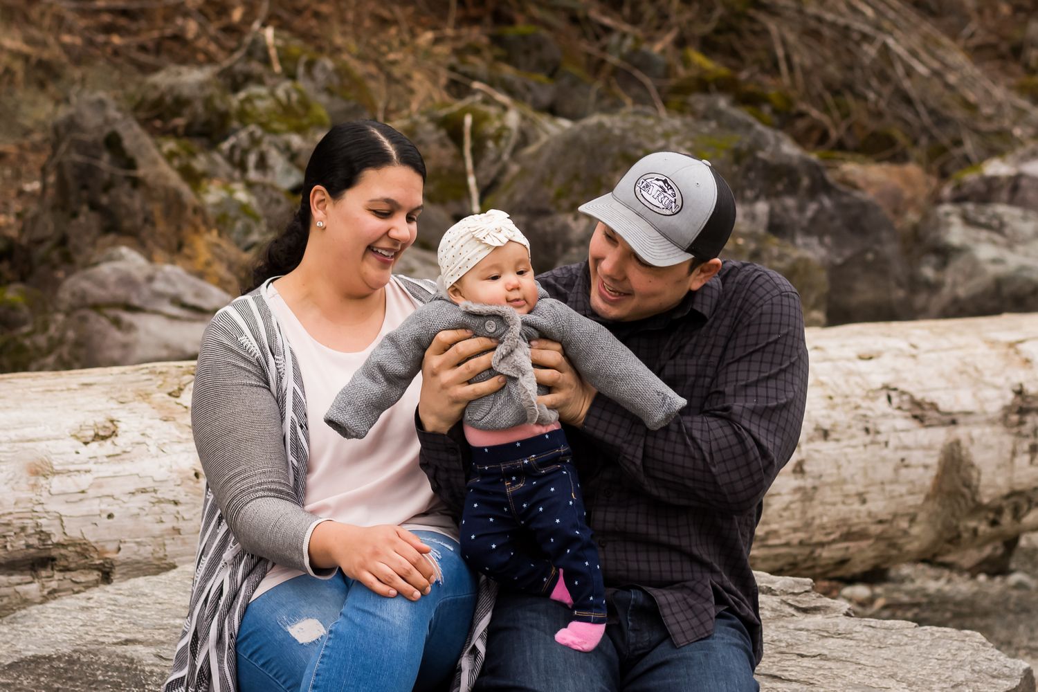 Family smiling together outside in nature at Alouette Lake in Maple Ridge