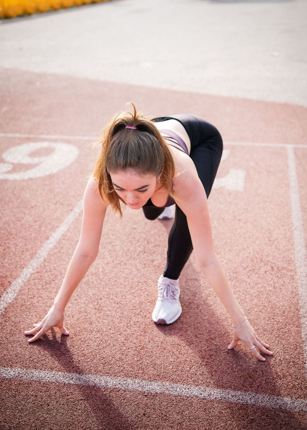 woman on santa barbara city college track team getting ready to sprint