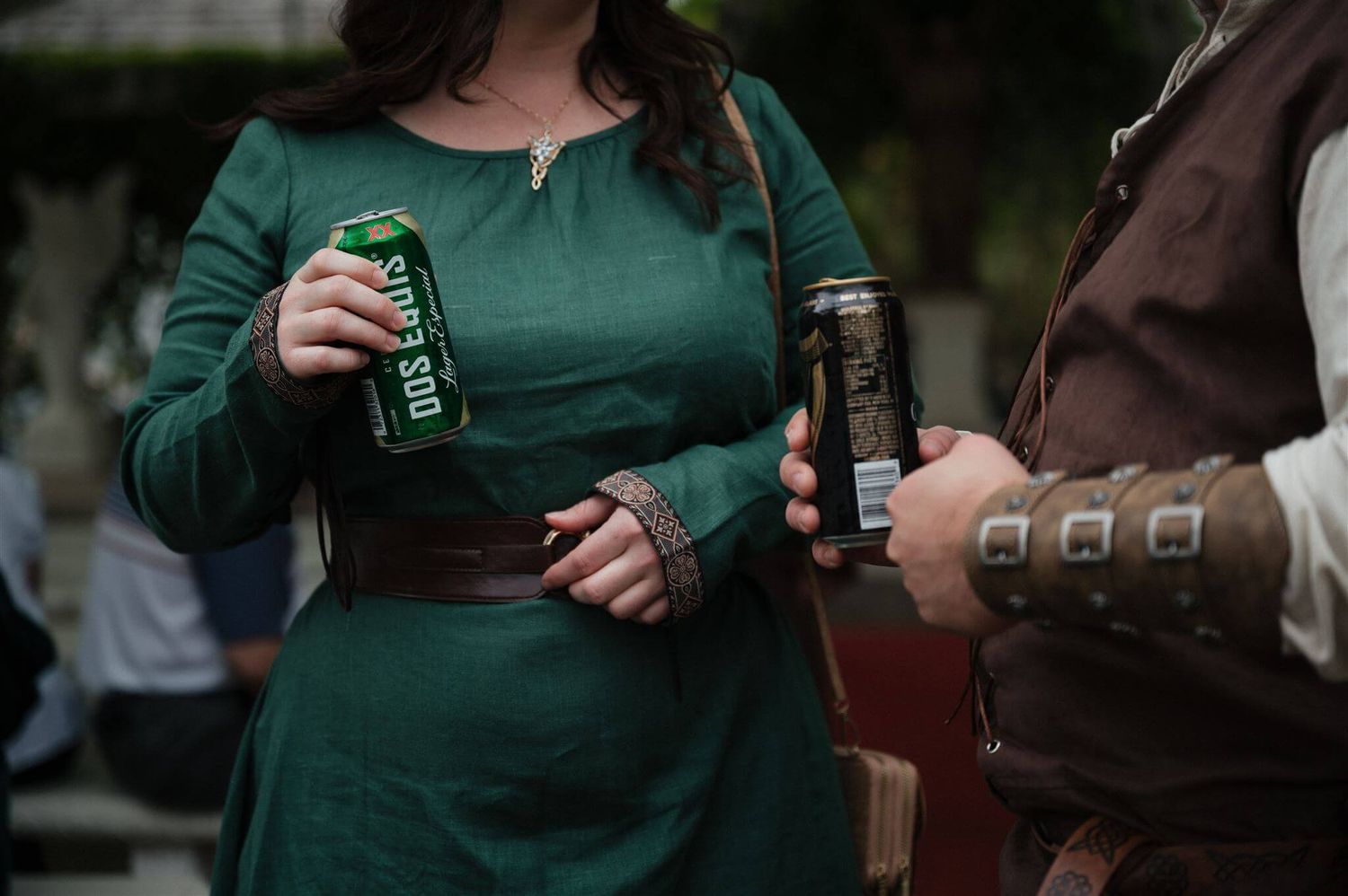 Detail shot of medieval-costumed guests holding beverages in period-appropriate dress.