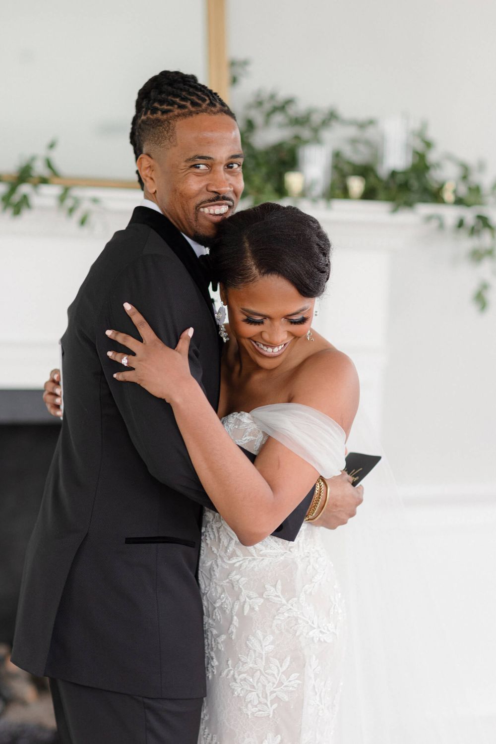 Joyful wedding couple embracing and laughing during their first look photos.