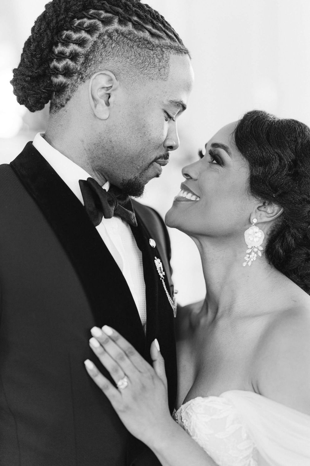 Intimate black and white portrait of newlyweds sharing a romantic moment.
