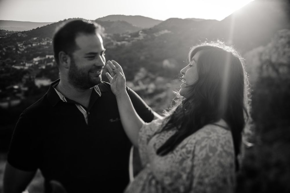A playful moment between a couple during their sunset maternity photo session in the mountains.