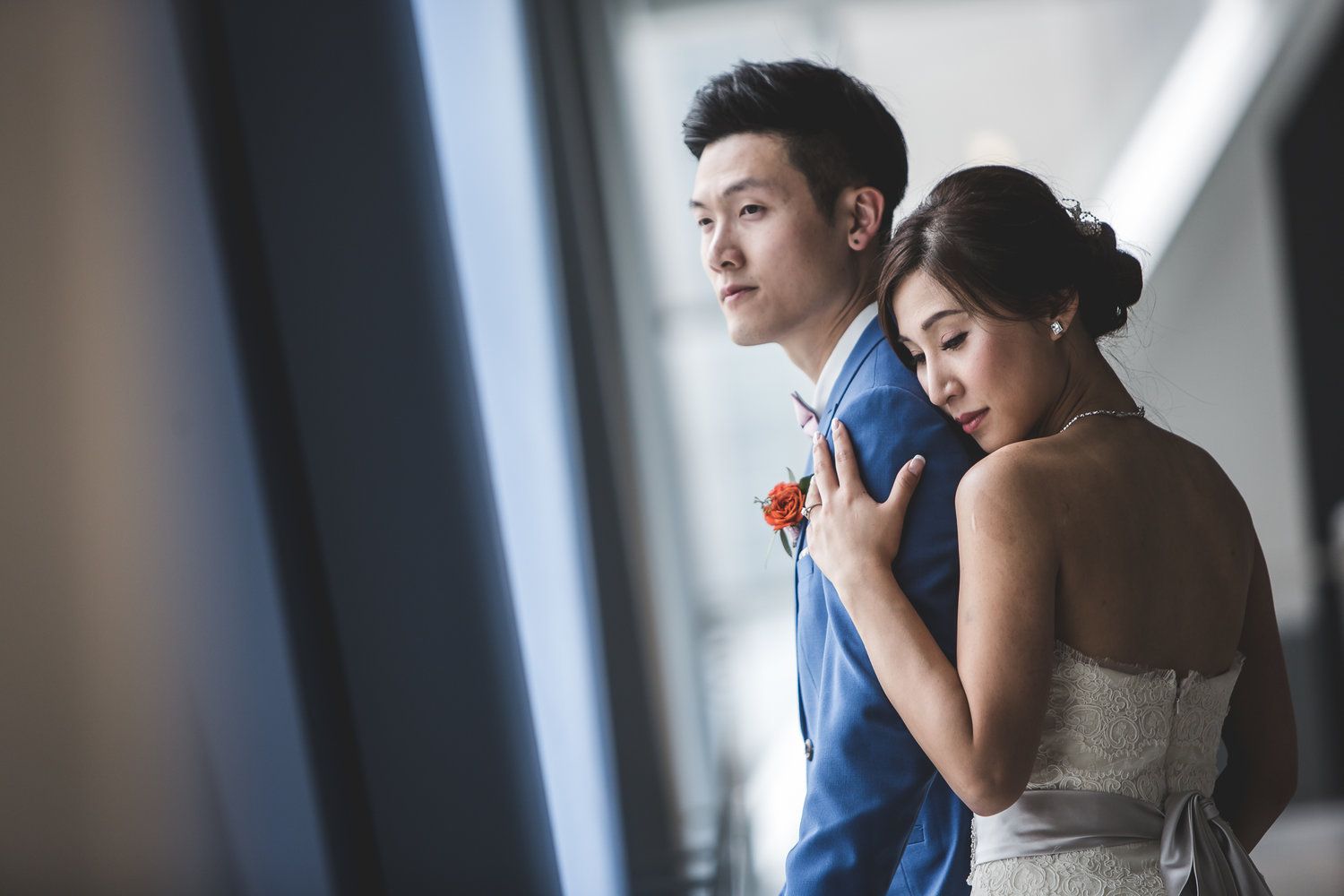 Asian couple posing in front of natural light window