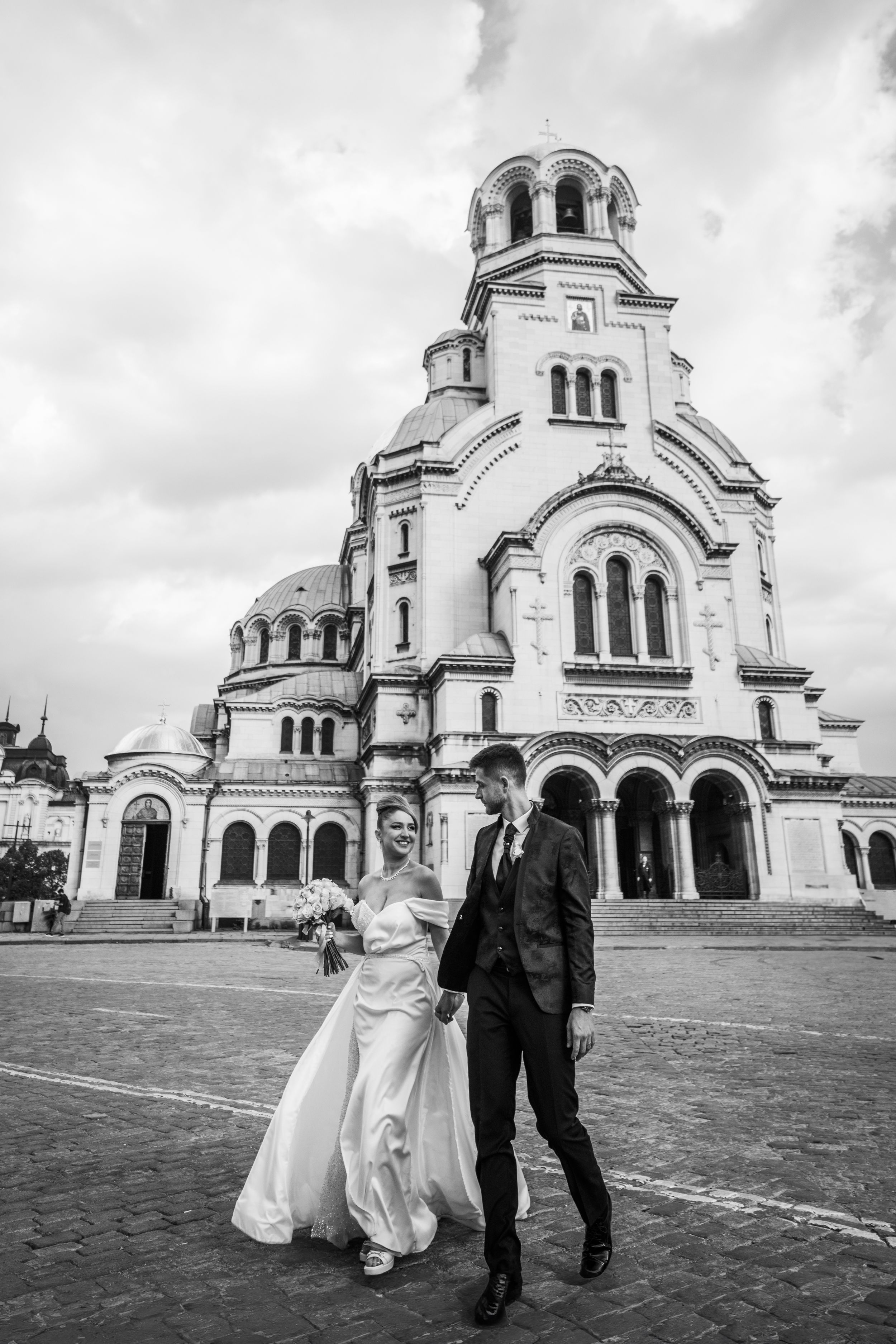 A bride and groom pose in front of the stunning Alexander Nevsky Cathedral in Sofia, Bulgaria.
