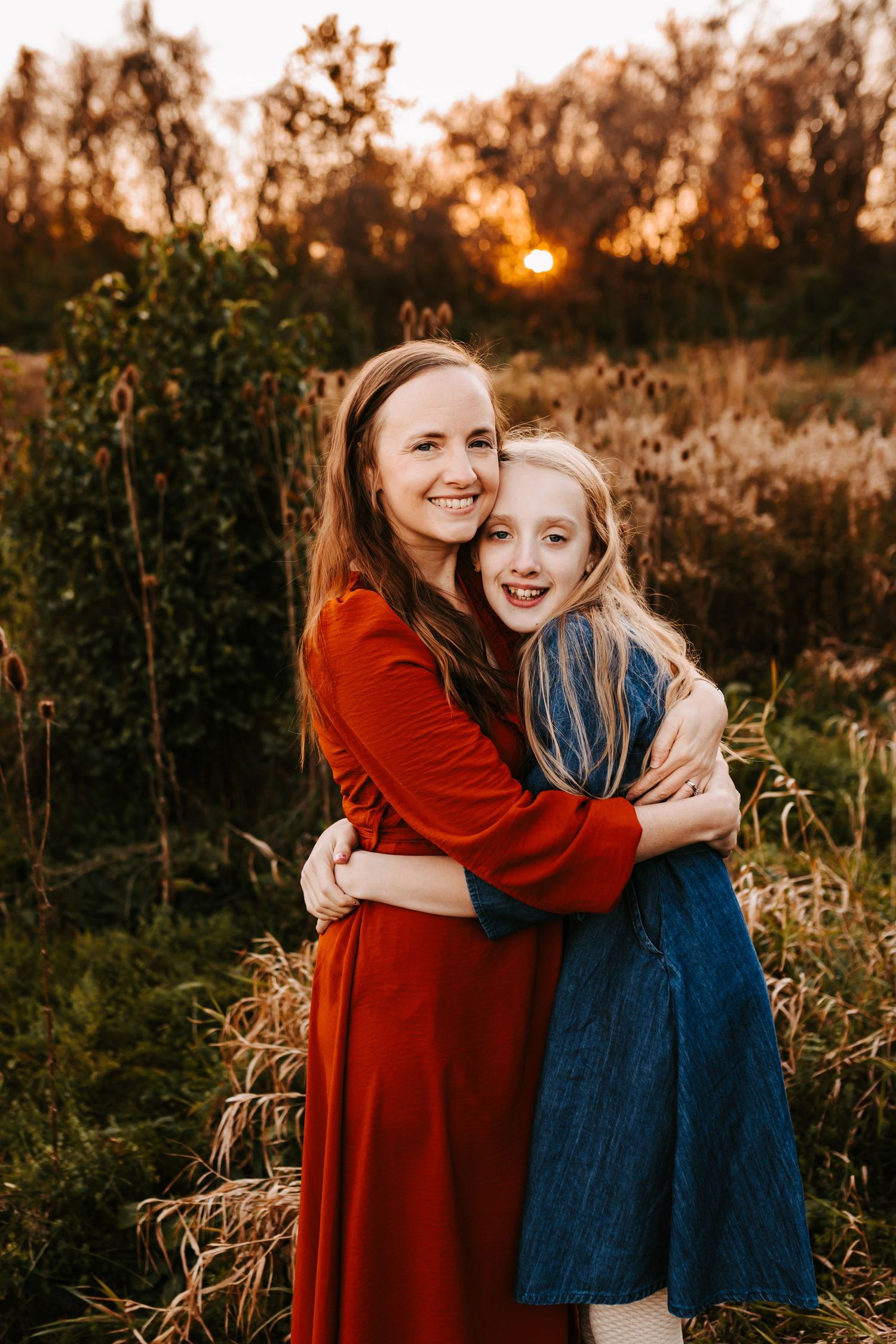 A warm sunset portrait in a natural field setting with golden light.