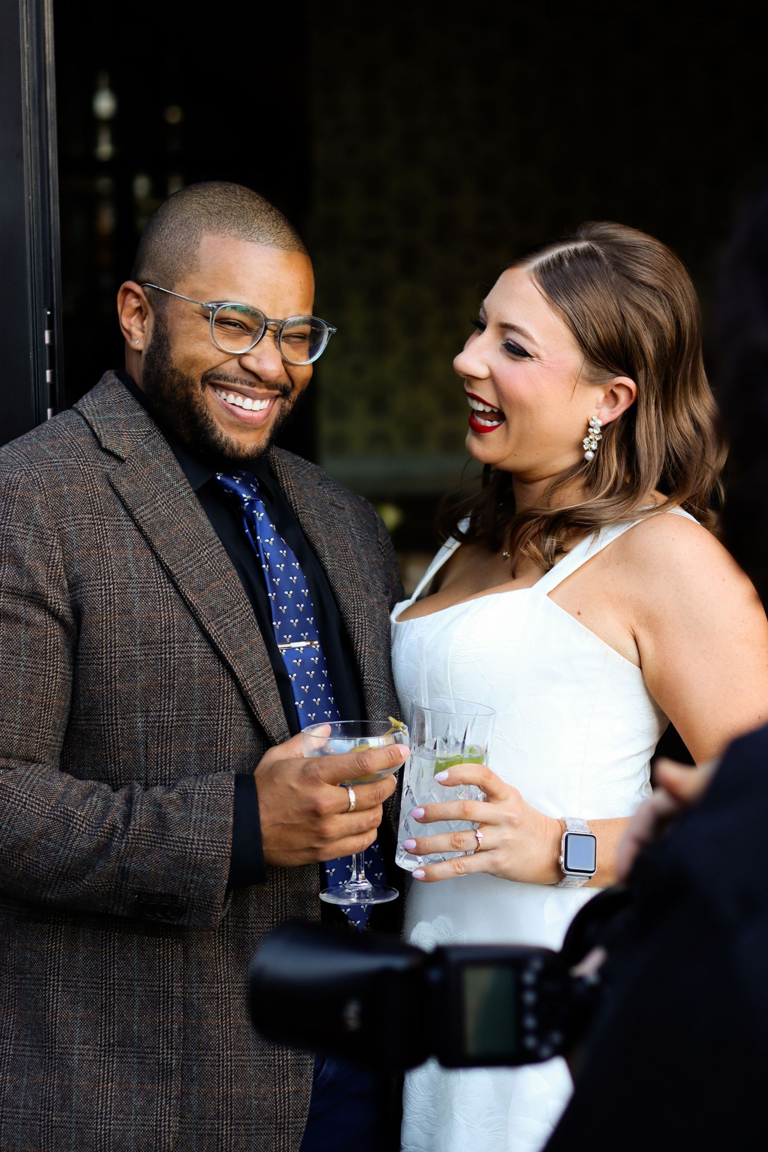 A couple laughs while getting their photos taken at their rehearsal dinner in Dallas, Texas.