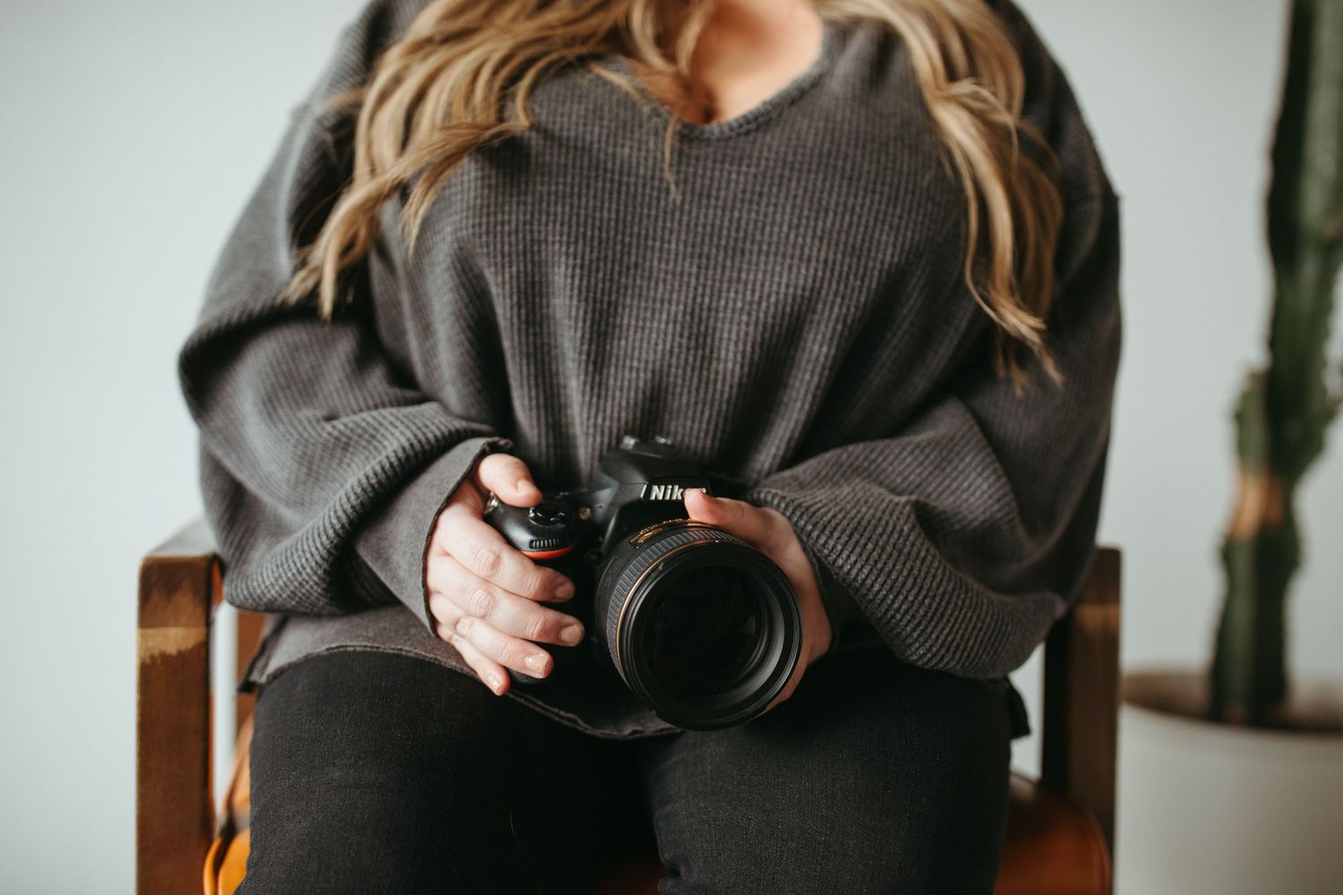 Candid moments captured during indoor photography session with cozy sweater.