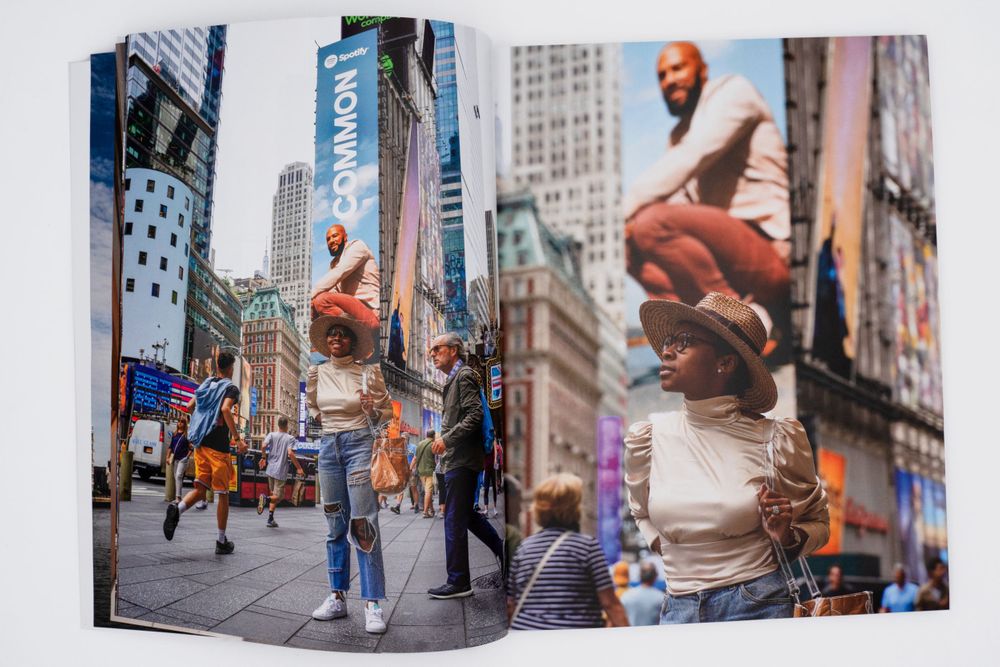 Magazine spread featuring people jumping and posing in Times Square with bright digital billboards.