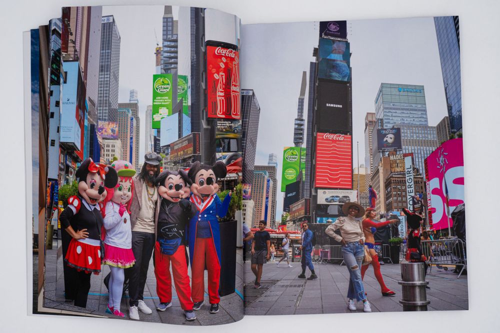 Magazine spread showing tourists and neon signs in bustling Times Square, New York City.