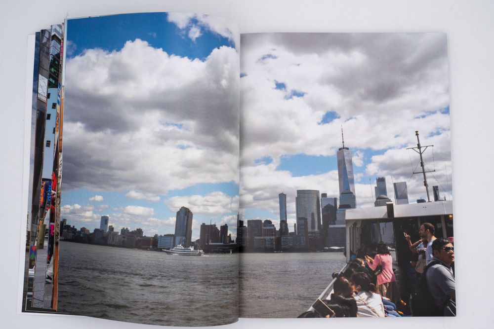 Magazine spread featuring New York City skyline view across water under cloudy sky.