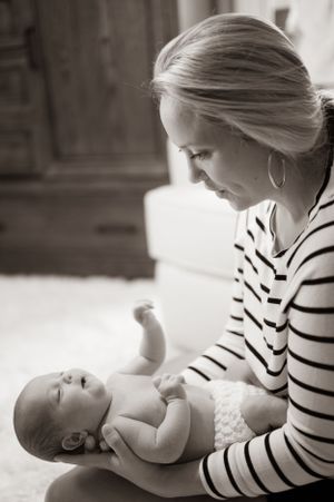An intimate black and white portrait capturing a tender parenting moment.