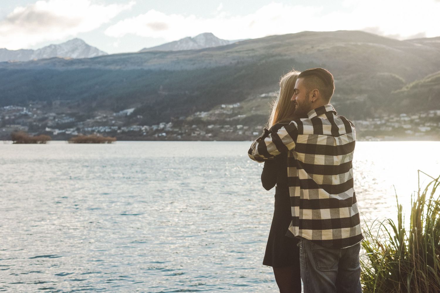 Couple embracing looking at a lake