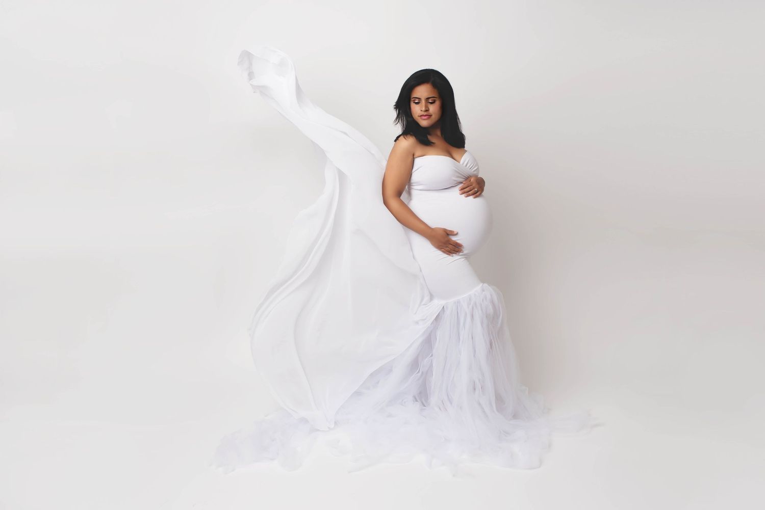 white backdrop with white gown dress maternity photo