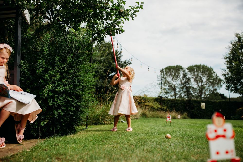 Playful outdoor scene of children jumping and playing in a sunny garden.