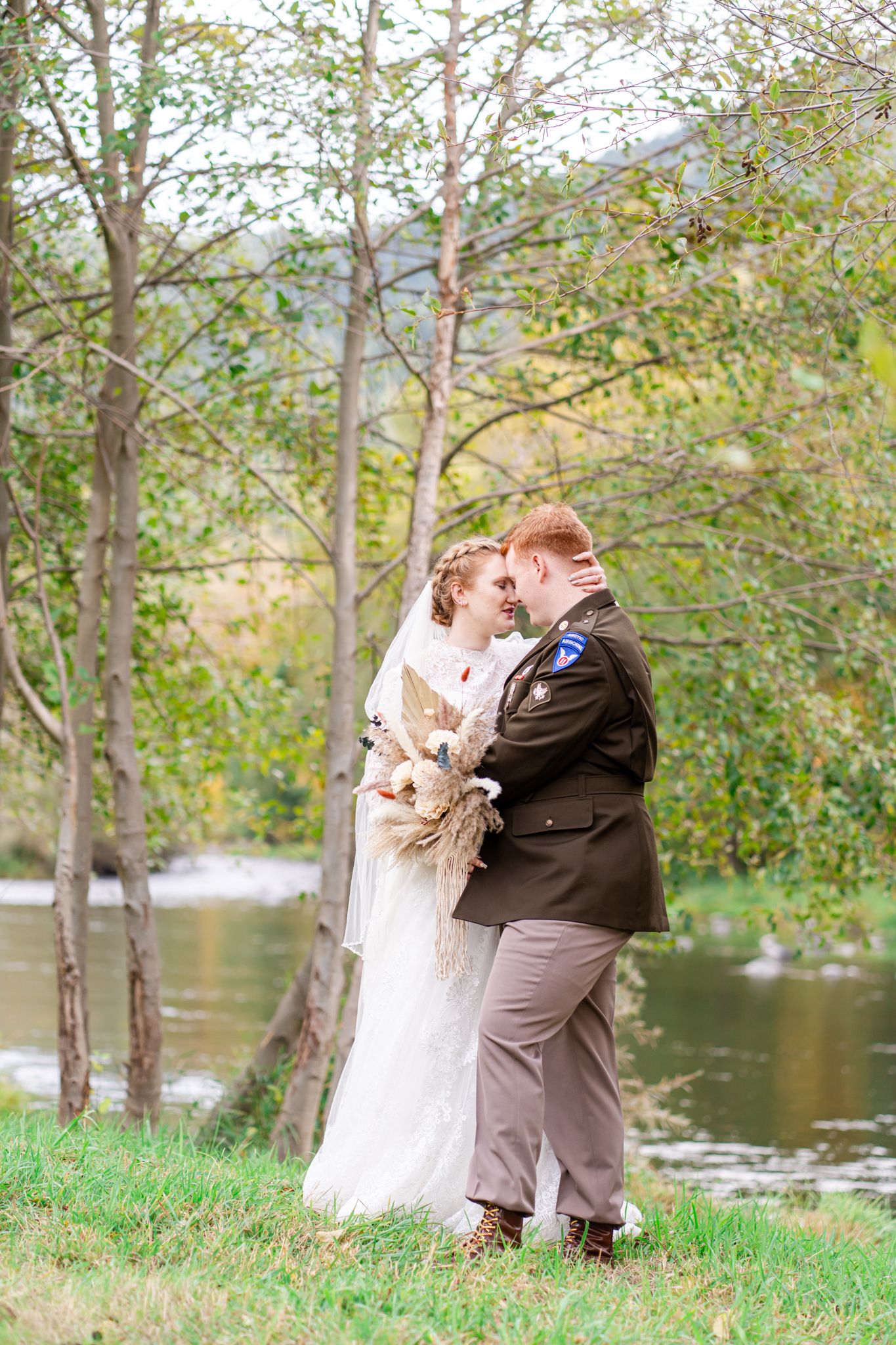 bride and groom embrace by the Applegate River