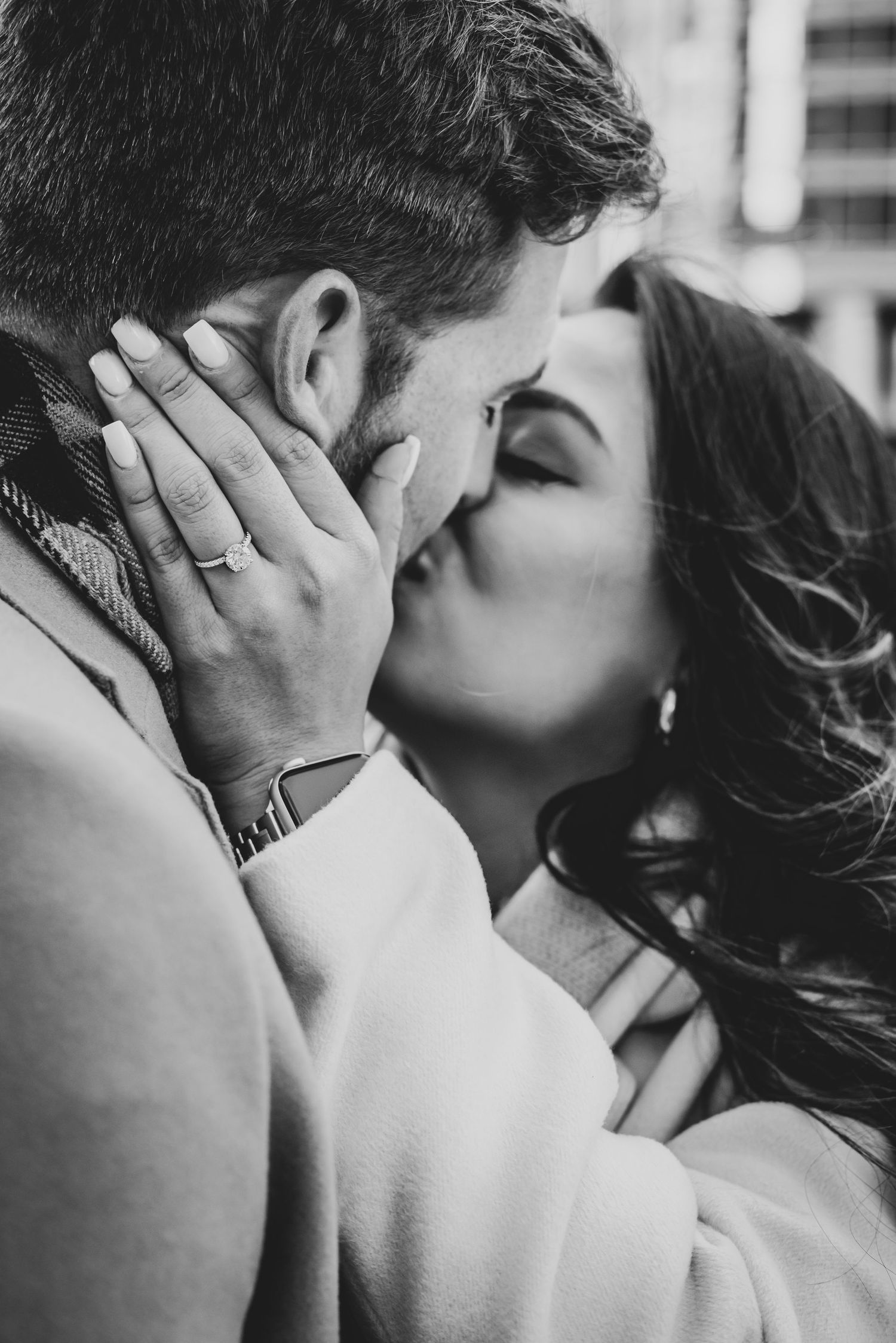 Newly engaged couple kiss close up