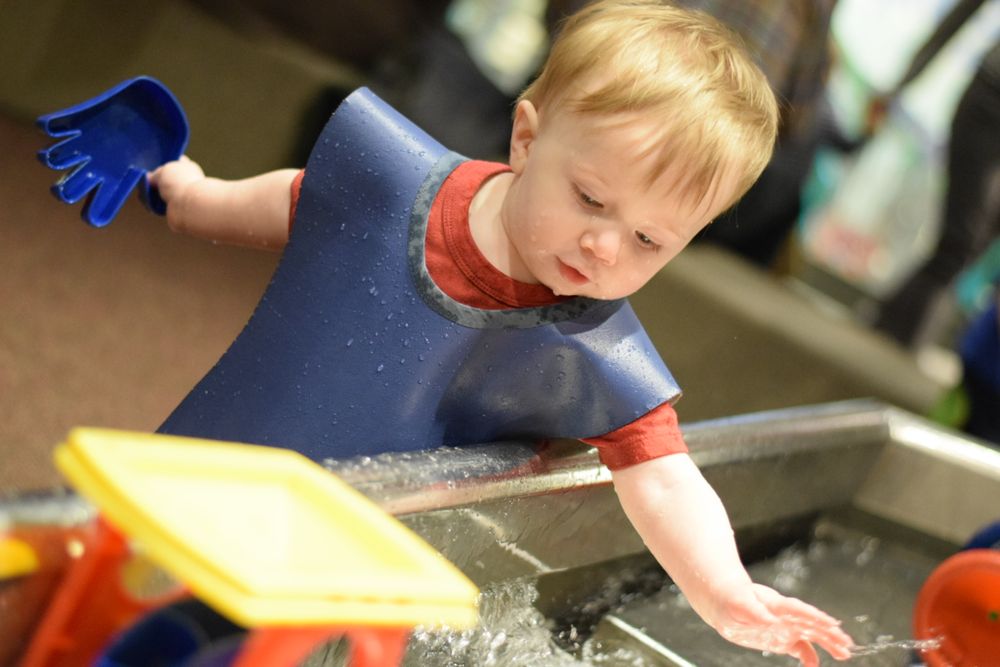Children engaged in creative play activities with colorful toys and materials.