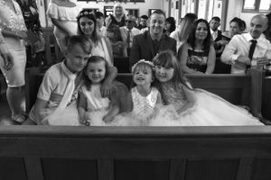Black and white photo of wedding reception guests enjoying celebration.