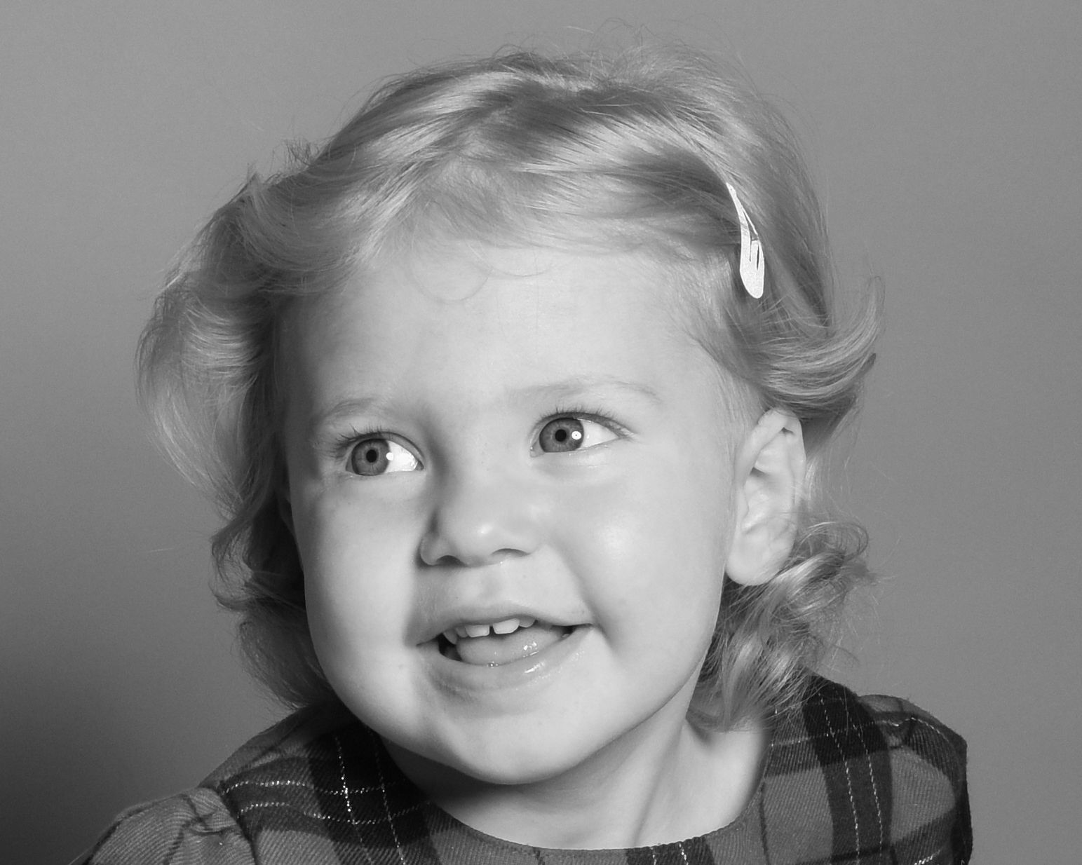 Series of black and white portraits showing joyful expressions and smiles.