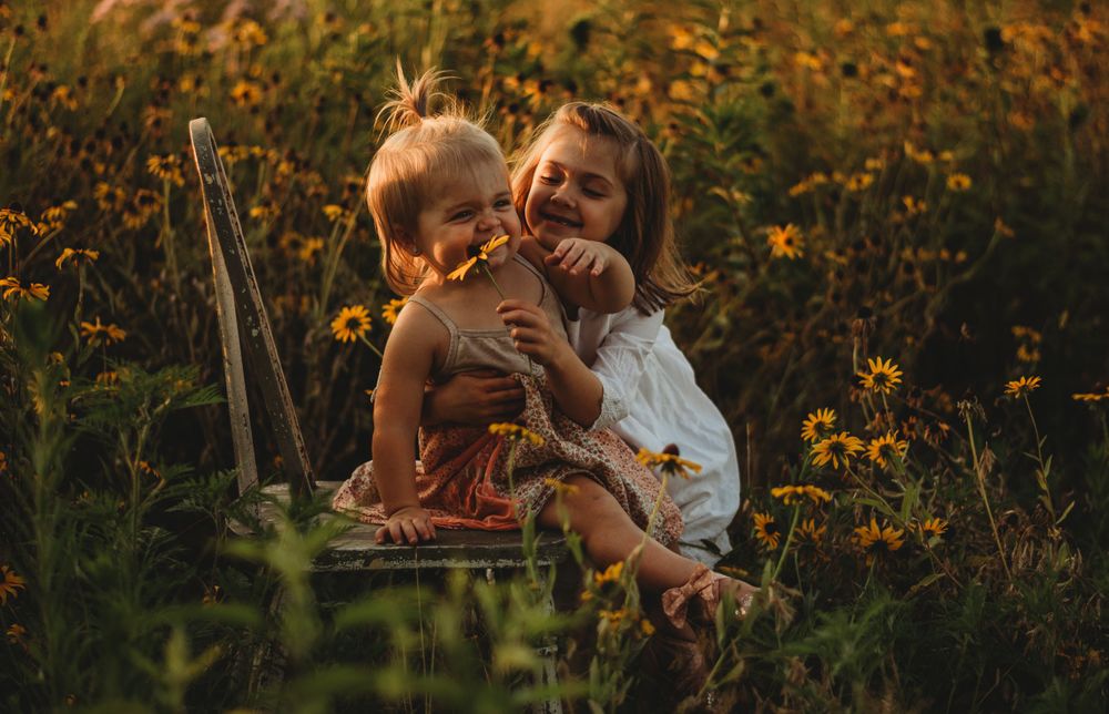 sisters in yellow flower field