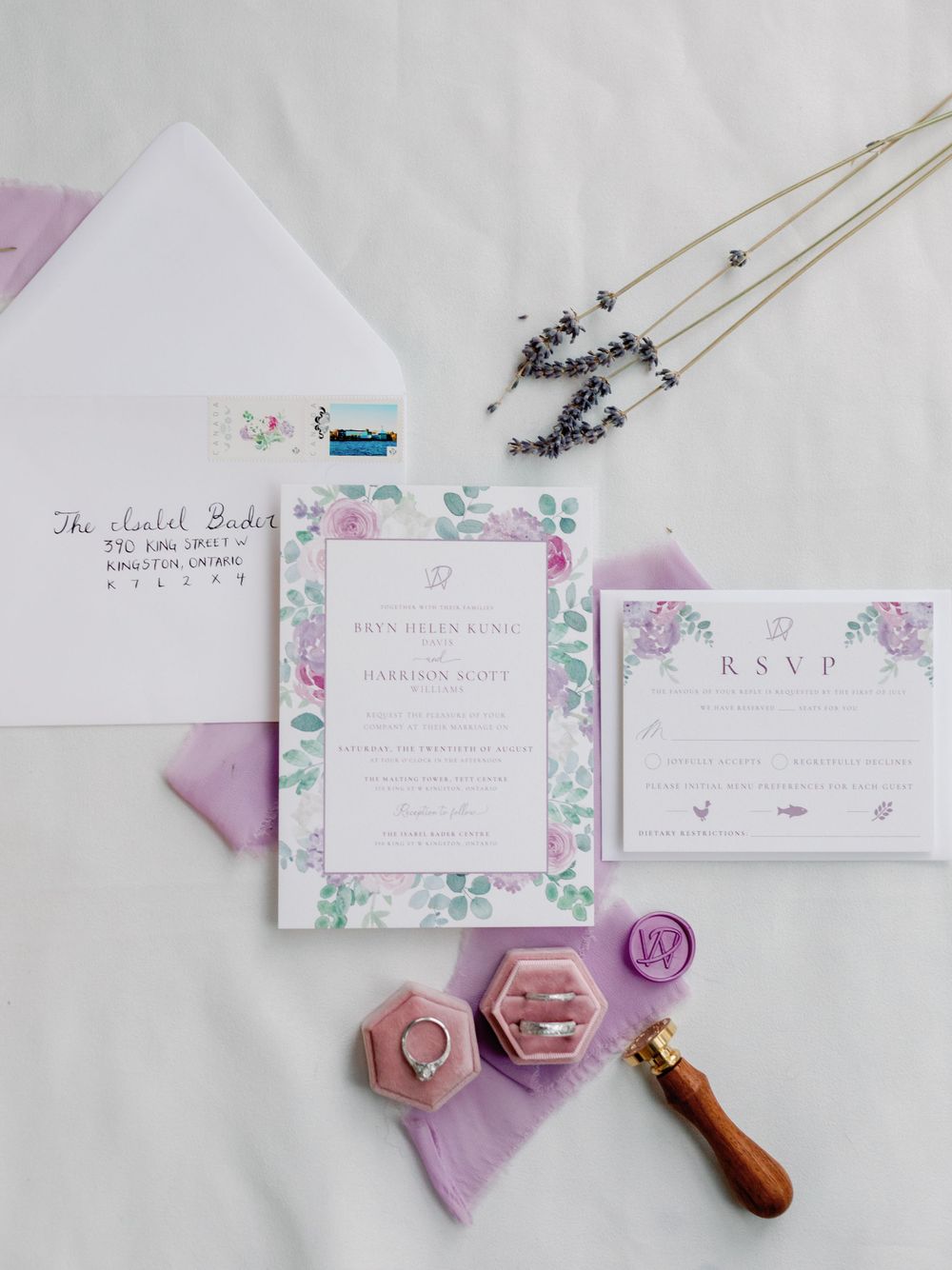 Wedding stationery suite featuring watercolor florals and wax seals on purple fabric.