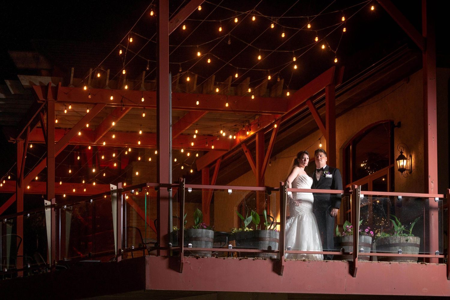 Rustic wedding venue with string lights creating romantic ambiance.