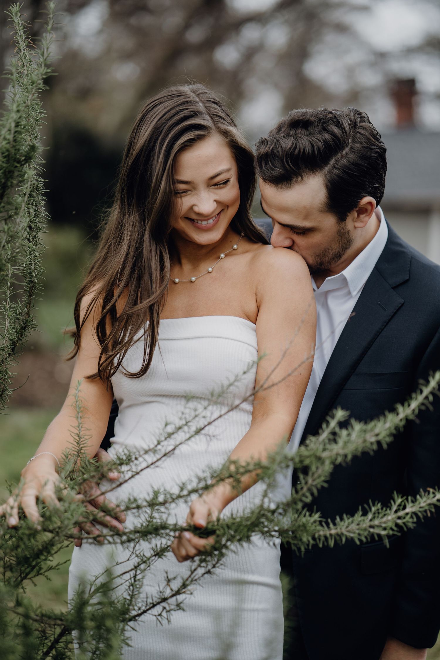 groom kissing the shoulder of the bride